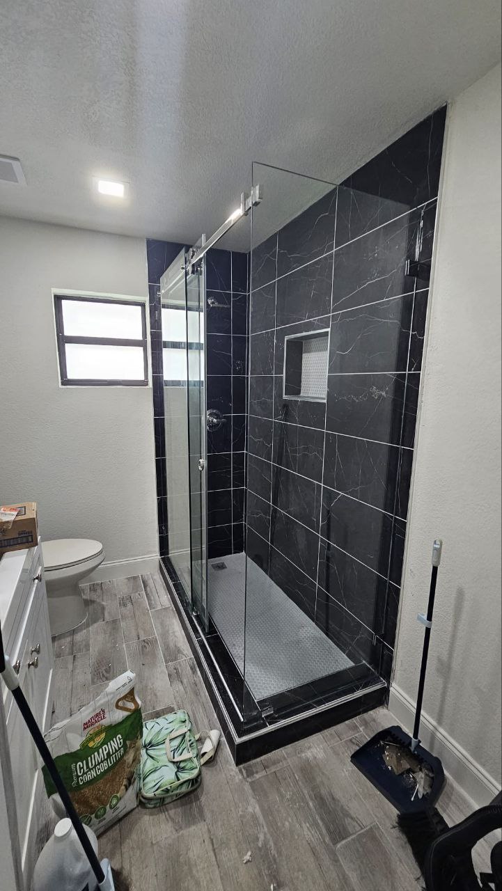 Black marble tile, frameless glass shower