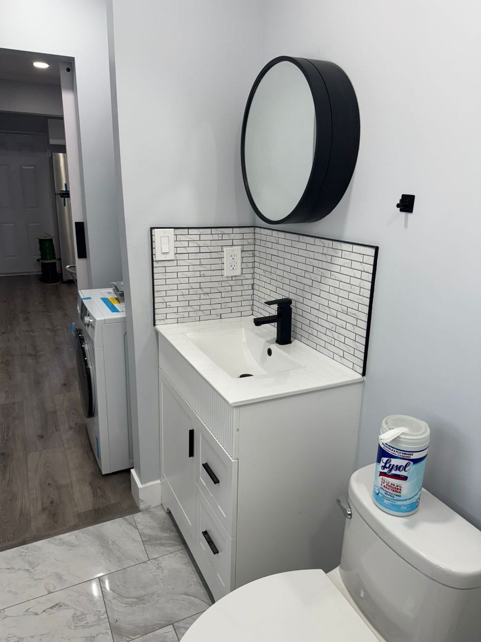 Modern vanity, in-unit W/D visible in background