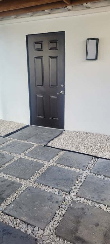 Black entry door, stamped paver pathway