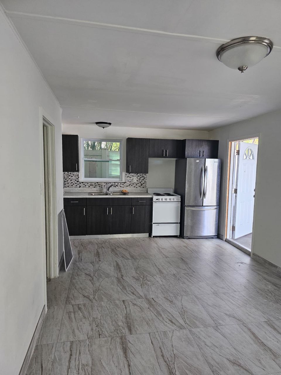 Espresso cabinets, marble-look floors, stainless appliances