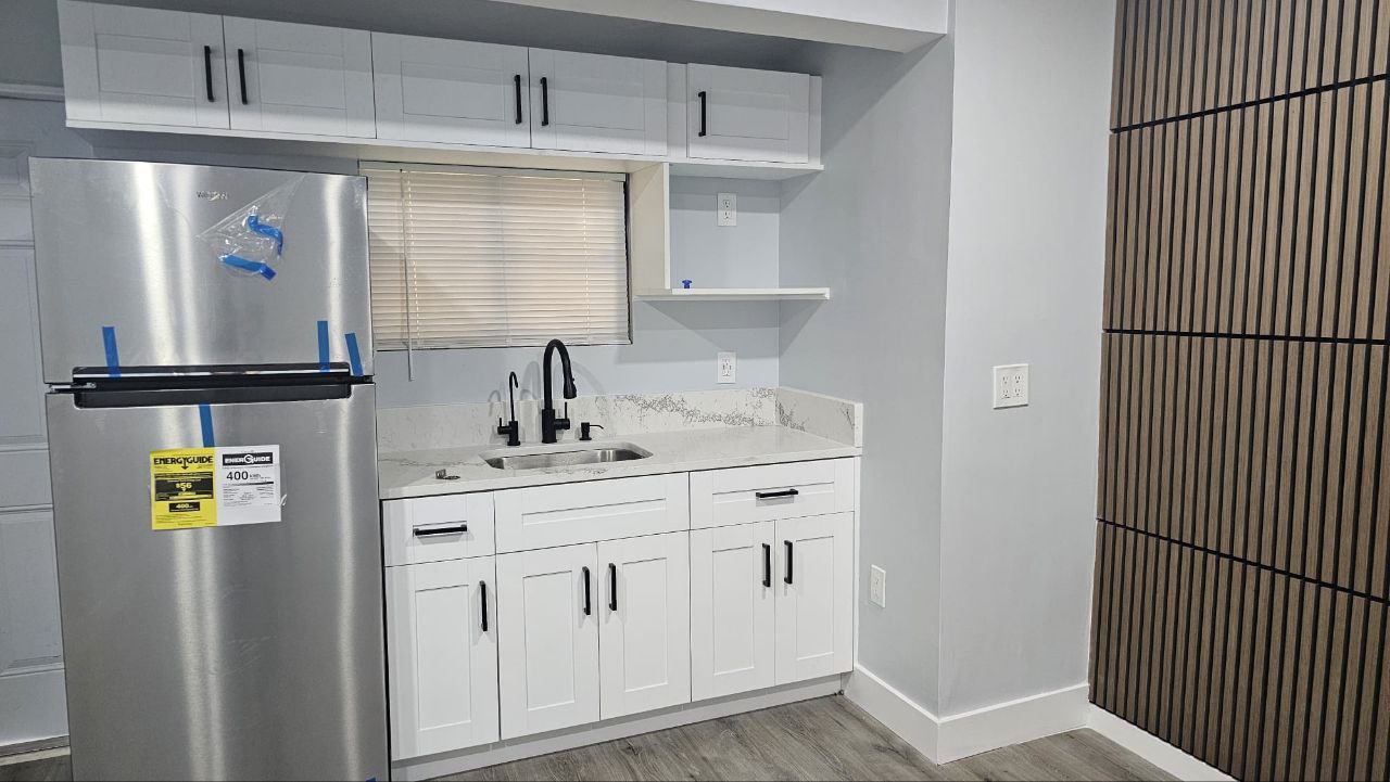 New white shaker cabinets, designer slat wood accent wall